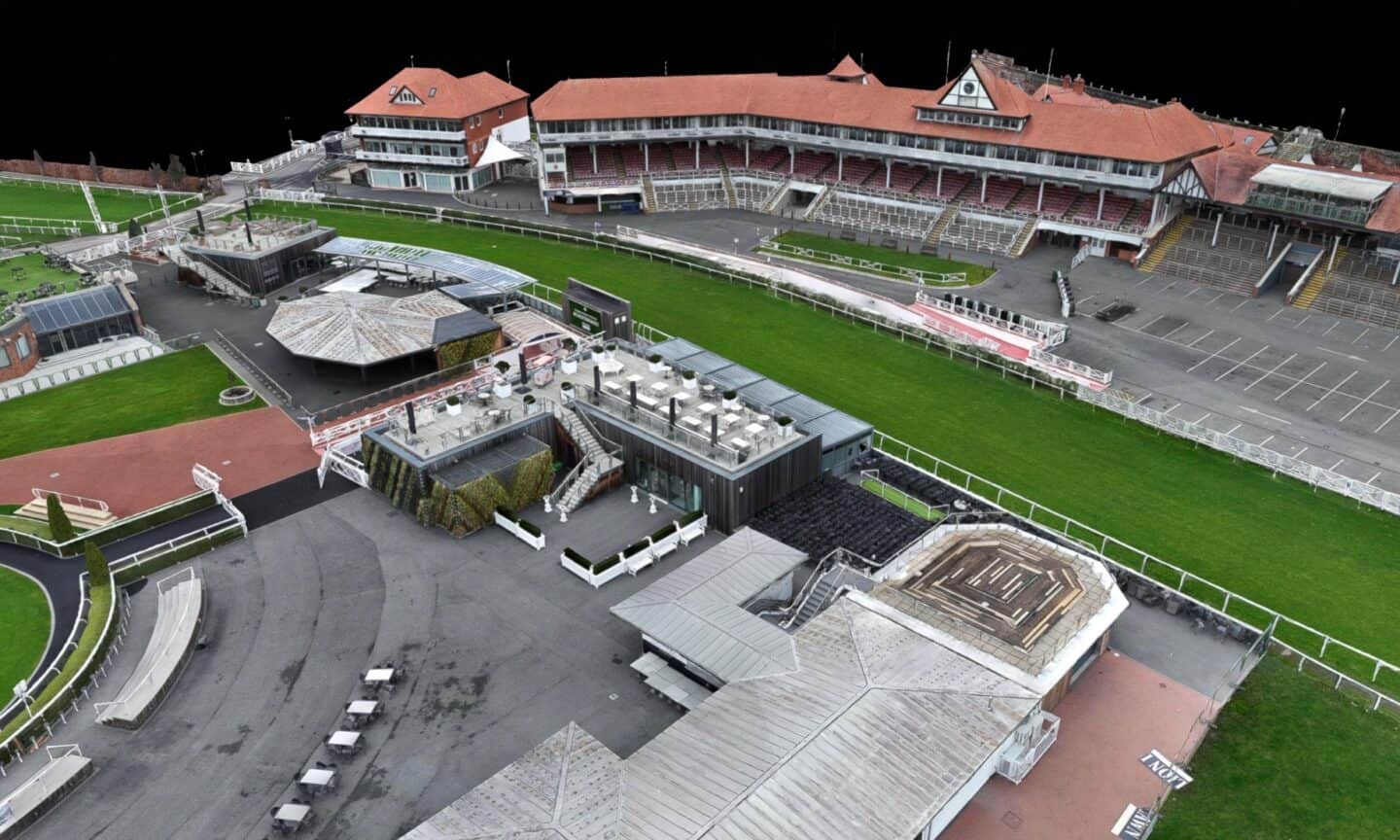 Aerial view of Chester Racecourse with grandstand and racing track.