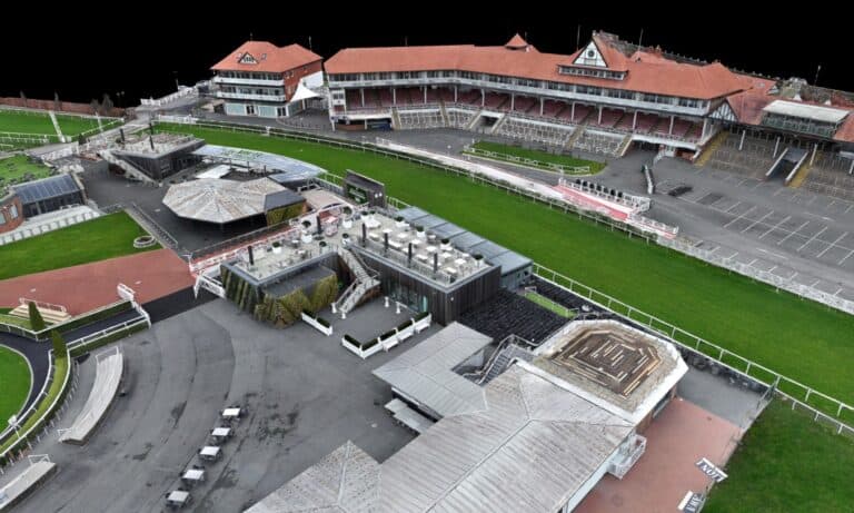 Aerial view of Chester Racecourse with grandstand and racing track.