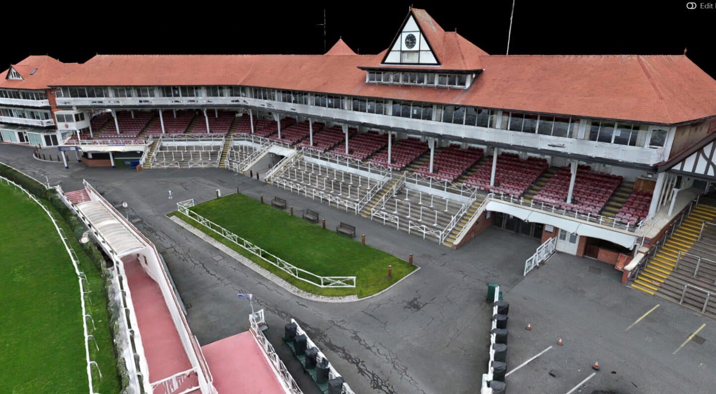 View of Ascot Racecourse grandstand and race track in daylight.