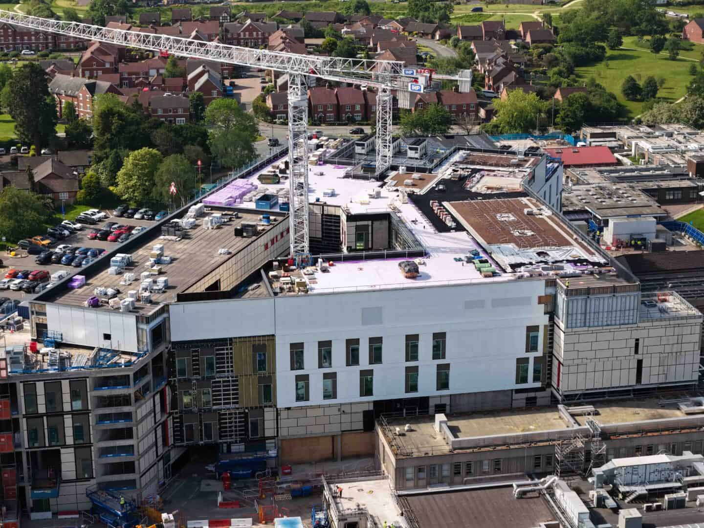 Construction site with cranes and modern building under development.
