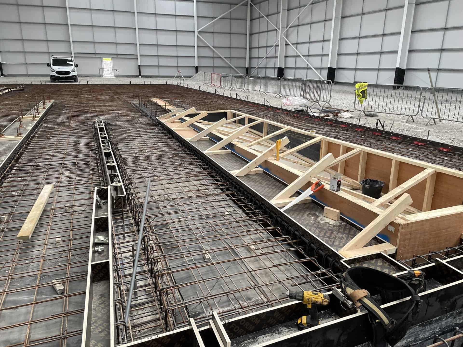 Construction site with rebar and formwork for concrete slab.