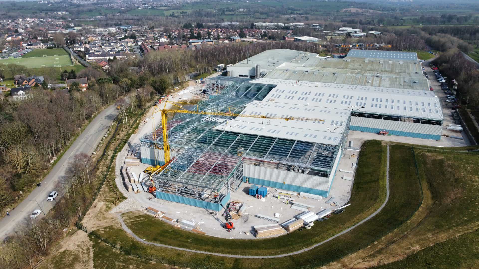 Construction site with cranes and building framework in progress.