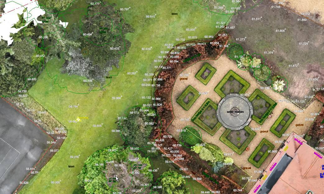 Aerial view of a landscaped garden with geometric patterns and lush greenery.