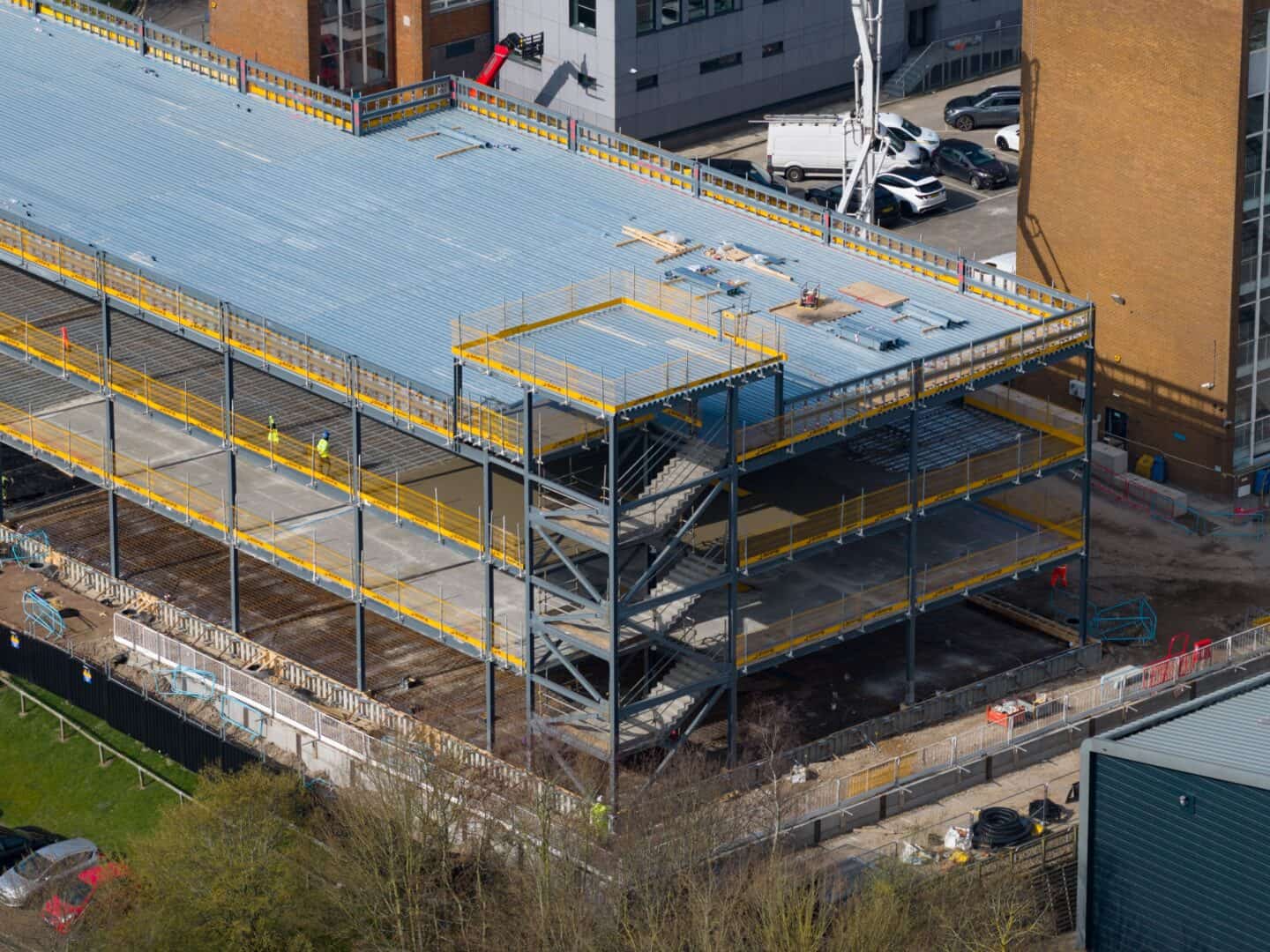 Construction site of a multi-story commercial building with steel framework.
