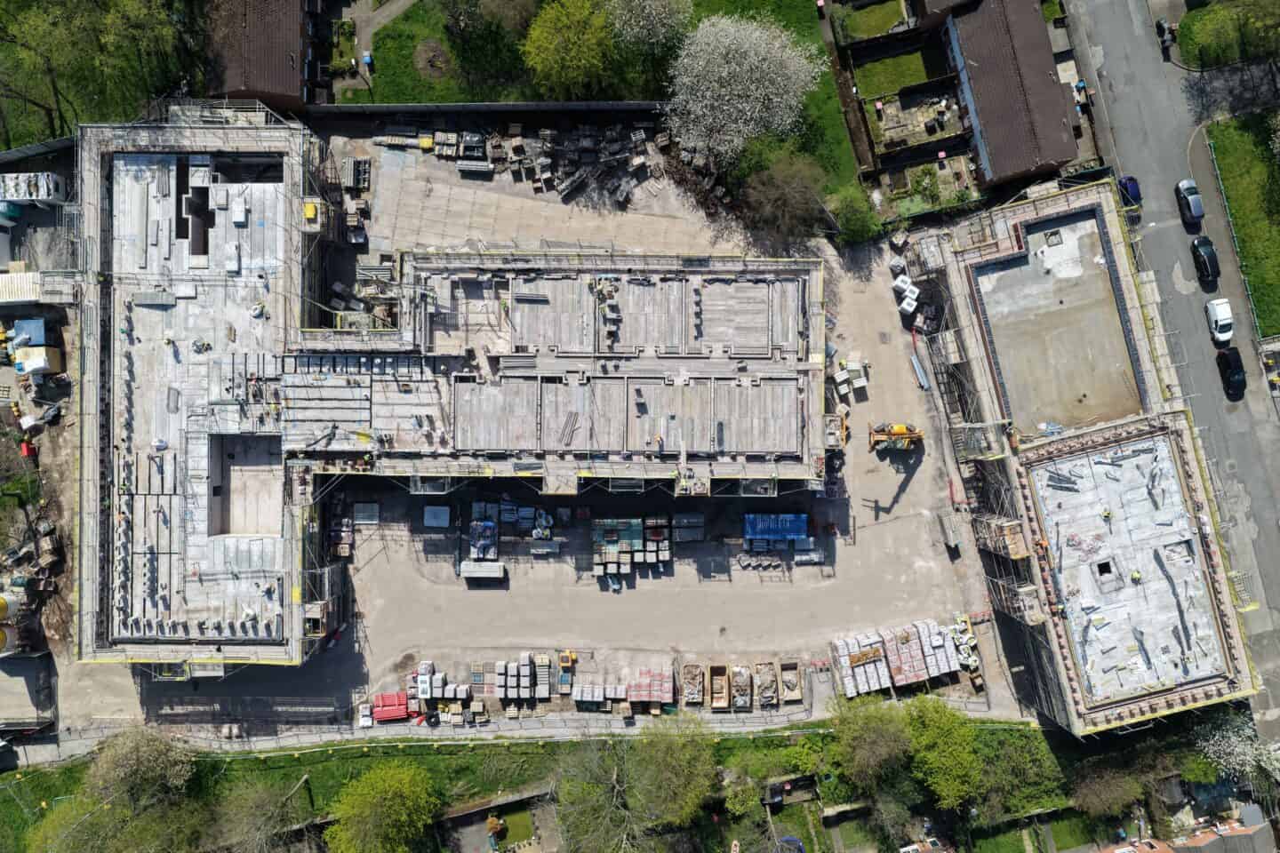 Aerial view of a construction site with building framework and equipment.