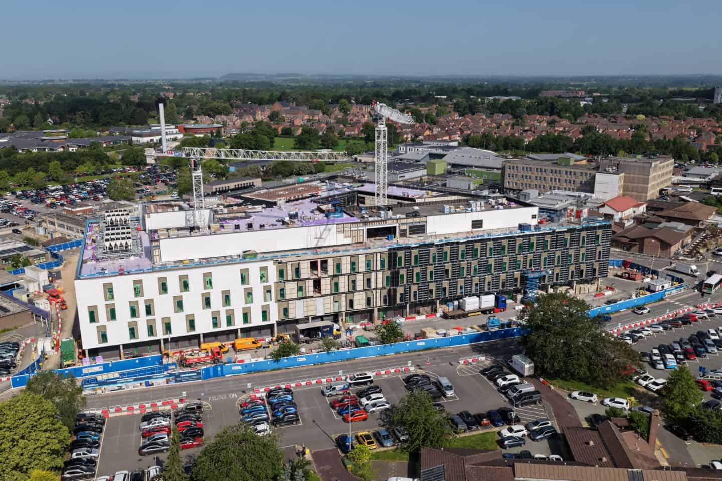 Construction site of Royal Shrewsbury Hospital with cranes and building framework.