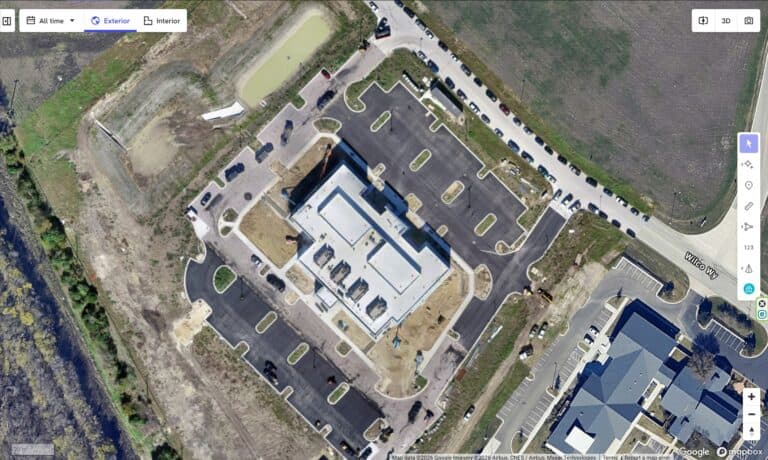 Aerial view of Bryant Site Services building and parking lot in a commercial area.