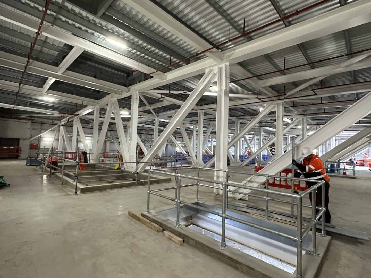 Modern industrial building with steel framework and safety railings.