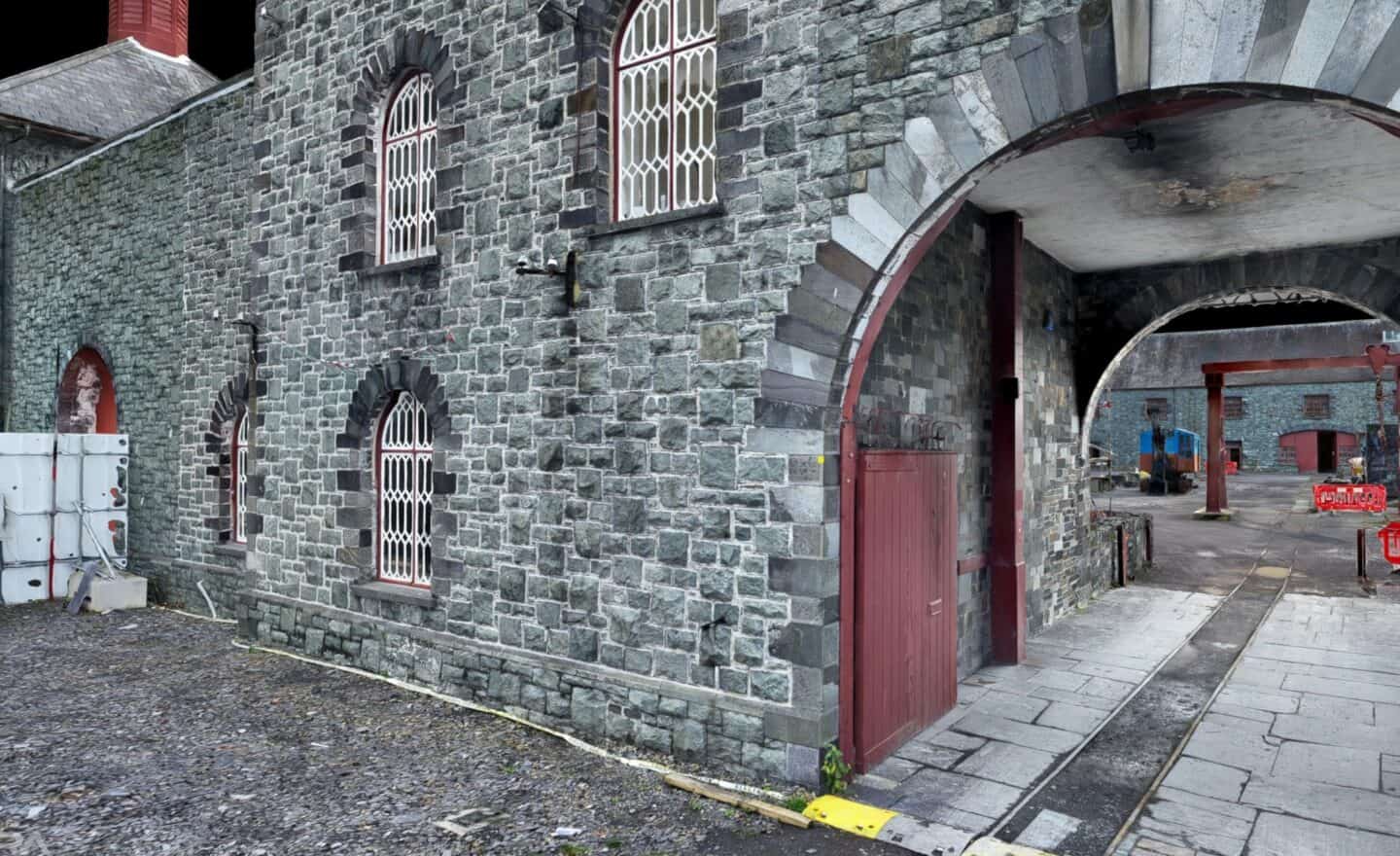 Construction site with stone building and archway for Bryant Site Services.
